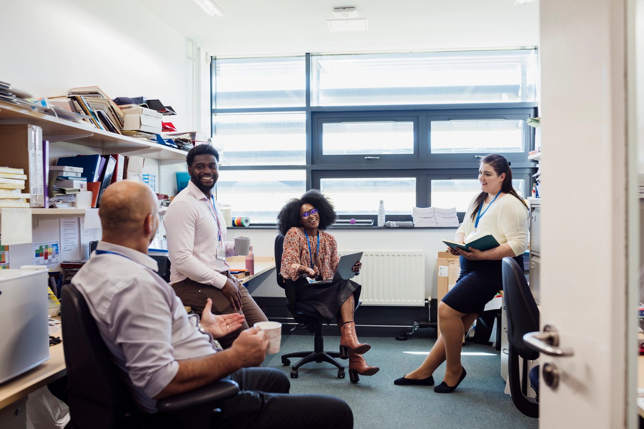 Support team meeting together in an office